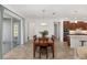Bright dining room with hardwood floors, large windows and a table for six at 9350 Sw 91St Court Rd, Ocala, FL 34481