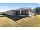 House exterior showcasing screened porch and yard at 9350 Sw 91St Court Rd, Ocala, FL 34481