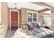 Front porch with red door and seating area at 9350 Sw 91St Court Rd, Ocala, FL 34481