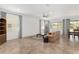 Open concept living room with tile floors, large windows and a ceiling fan at 9350 Sw 91St Court Rd, Ocala, FL 34481