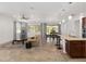 Bright living room features tile floors, a neutral colored sofa and a large window at 9350 Sw 91St Court Rd, Ocala, FL 34481