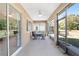 Bright screened porch with seating area and view of backyard at 9350 Sw 91St Court Rd, Ocala, FL 34481