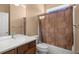 Bathroom with shower/tub combo and brown vanity at 9826 Sw 63Rd Loop, Ocala, FL 34481