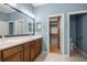 Double vanity bathroom with walk-in closet access at 9826 Sw 63Rd Loop, Ocala, FL 34481