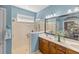 Bathroom with walk-in shower, double vanity, and stylish mirror at 9826 Sw 63Rd Loop, Ocala, FL 34481