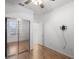 Bedroom with mirrored closet doors and wood flooring at 9826 Sw 63Rd Loop, Ocala, FL 34481