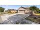Front view of a single story house with a two-car garage and circular driveway at 9826 Sw 63Rd Loop, Ocala, FL 34481