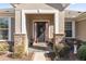 Front entrance with stone accents and a red door at 9826 Sw 63Rd Loop, Ocala, FL 34481
