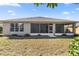 House back view showing a screened porch and landscaped yard at 9826 Sw 63Rd Loop, Ocala, FL 34481