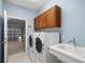 Laundry room with washer, dryer, cabinets, and utility sink at 9826 Sw 63Rd Loop, Ocala, FL 34481