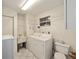 Bright laundry room, washer, dryer, sink, and shelving at 10816 Sw 83Rd Ave, Ocala, FL 34481