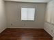 Spacious bedroom with wood flooring and window blinds at 10842 Se 50Th Ave # 1, Belleview, FL 34420