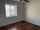 Second bedroom with wood flooring and a large window at 10842 Se 50Th Ave # 1, Belleview, FL 34420