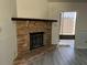 Brick fireplace in the living room with a modern gas insert at 10842 Se 50Th Ave # 1, Belleview, FL 34420