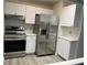 Modern kitchen featuring stainless steel appliances and white cabinets at 10842 Se 50Th Ave # 1, Belleview, FL 34420