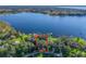 Aerial view of waterfront property with expansive lake views and lush landscaping at 11754 Se 123Rd St, Belleview, FL 34420