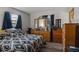 Bedroom with wood dresser, double bed and window coverings at 17411 Se 18Th St, Silver Springs, FL 34488