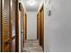 Hallway with wood-paneled doors and laminate flooring at 17411 Se 18Th St, Silver Springs, FL 34488