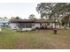 Rear view of house showing screened porch and AC unit at 17411 Se 18Th St, Silver Springs, FL 34488
