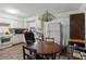 Bright kitchen features white cabinets, laminate flooring, and a round dining table at 17411 Se 18Th St, Silver Springs, FL 34488