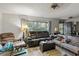 Spacious living room with leather couches and large windows at 17411 Se 18Th St, Silver Springs, FL 34488