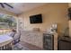 Outdoor bar area with mini-fridge and TV at 17819 Sw 61St Lane Rd, Dunnellon, FL 34432