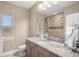 Bathroom with granite countertop, tiled shower, and updated fixtures at 17819 Sw 61St Lane Rd, Dunnellon, FL 34432