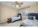 Bedroom with two twin beds, ceiling fan and window with blinds at 17819 Sw 61St Lane Rd, Dunnellon, FL 34432