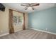 Bedroom with ceiling fan, window with drapes, and neutral tones at 17819 Sw 61St Lane Rd, Dunnellon, FL 34432