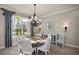 Elegant dining room with a large round table, chandelier, and neutral decor at 17819 Sw 61St Lane Rd, Dunnellon, FL 34432