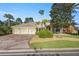 Beautiful home with three car garage, lush landscaping, and brick paver driveway at 17819 Sw 61St Lane Rd, Dunnellon, FL 34432