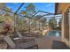Relaxing pool area with lounge chairs and covered patio at 17819 Sw 61St Lane Rd, Dunnellon, FL 34432