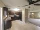 Dark wood kitchen cabinets and tile floors at 21 Maple Crse, Ocklawaha, FL 32179