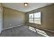 Well-lit bedroom with carpeted floor and a window with natural light at 225 Sw Pineapple Hill Dr, Dunnellon, FL 34431