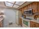Kitchen with wood cabinets, appliances, and tile floor at 3031 Se 5Th Ter # C, Ocala, FL 34471