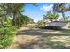 Large backyard with mature trees and a view of the house at 3590 Sw 24Th Avenue Rd, Ocala, FL 34471