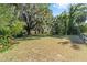 Large backyard with mature trees and a wooden fence at 3590 Sw 24Th Avenue Rd, Ocala, FL 34471