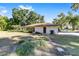Rear view of the house, showcasing landscaping and large yard at 3590 Sw 24Th Avenue Rd, Ocala, FL 34471
