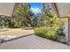 Spacious tiled patio overlooking a large backyard with mature trees at 3590 Sw 24Th Avenue Rd, Ocala, FL 34471