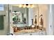 Bathroom boasts a granite vanity, large mirror, and updated light fixtures at 3642 Nw 55Th Cir, Ocala, FL 34482