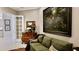 Spacious living room with green sofa, wooden cabinet, and large artwork at 3642 Nw 55Th Cir, Ocala, FL 34482