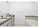 Double vanity bathroom with granite countertop and bathtub at 4313 Sw 106Th Pl, Ocala, FL 34476