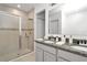 Double vanity bathroom with shower and granite countertop at 4313 Sw 106Th Pl, Ocala, FL 34476