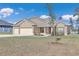One story home with three-car garage and partial stone facade at 4313 Sw 106Th Pl, Ocala, FL 34476