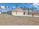 Tan house with three-car garage and a fire hydrant at 4313 Sw 106Th Pl, Ocala, FL 34476