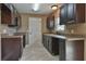 Modern kitchen with dark brown cabinets and granite countertops at 4730 Sw Hyacinth Ct, Dunnellon, FL 34431