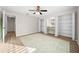 Spacious bedroom with a ceiling fan and double closets at 5570 Se 42Nd Ave, Ocala, FL 34480