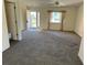 Living room with carpeted floors and access to entryway at 6011 Sw 98Th Street Rd, Ocala, FL 34476