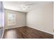 Bright bedroom featuring dark wood floors and a ceiling fan at 6560 Sw 129Th St, Ocala, FL 34473