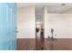 Inviting entryway with teal door and hardwood floors at 6560 Sw 129Th St, Ocala, FL 34473